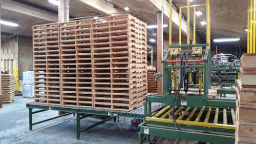 Built pallets ejected from the roll out table ready for use.