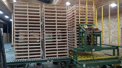 Built pallets staged on the roll out rollers and pallets collecting in the pallet stacker.